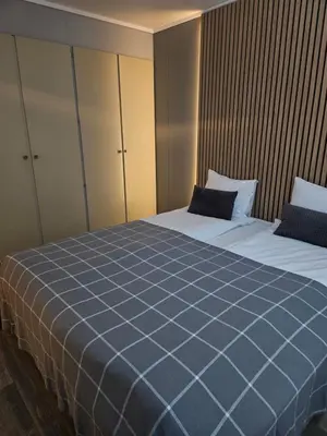 a bedroom with two beds with blue sheets at Leilighet Vingnes in Lillehammer