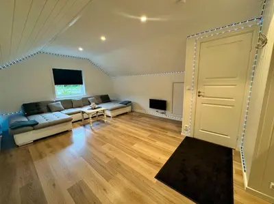 a living room with a couch and a table at Loft Apartment in Stranda