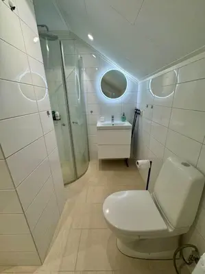 a white bathroom with a toilet and a sink at Loft Apartment in Stranda