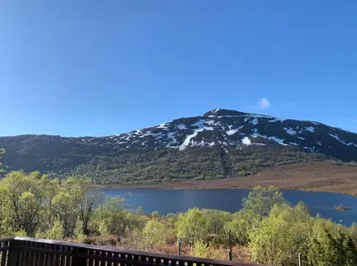 a mountain with a lake in front of it at Peaceful cabin retreat in the Norwegian mountains in Ulsteinvik