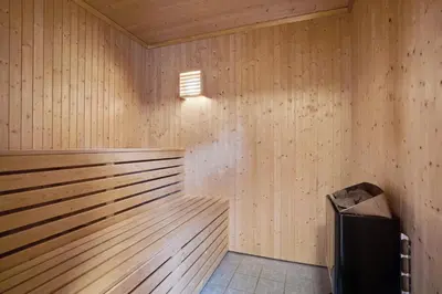 a wooden sauna with a trash can in it at Gunnarhytta, Valevåg in Valevåg