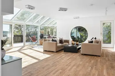 a living room with couches and a glass ceiling at 7 min to Ski Championship, Glass front house, Terrace in Trondheim