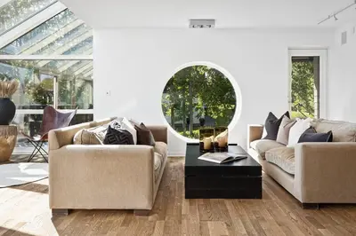 a living room with two couches and a table at 7 min to Ski Championship, Glass front house, Terrace in Trondheim