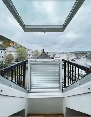 a balcony with a window with a blind on it at Apartment with Loft & Window Balcony, Free parking in Bergen