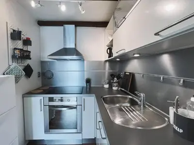 a kitchen with a sink and a stove at Apartment with Loft & Window Balcony, Free parking in Bergen