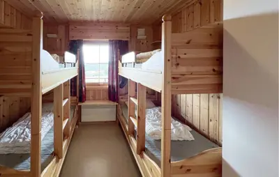 a room with four bunk beds in a cabin at Nice Home In Lillehammer With Sauna in Lillehammer