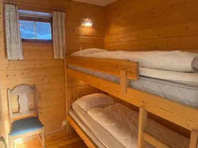 a bedroom with two bunk beds in a cabin at Steps From The Slopes With Stunning Views! in Beitostøl