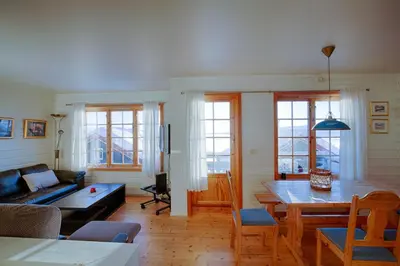 a living room with a couch and a table at Steps From The Slopes With Stunning Views! in Beitostøl