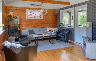 a living room with a couch and chairs and a table at 3 Bedroom Nice Home In Florø in Florø
