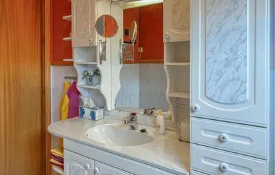 a bathroom with a sink and a mirror at 3 Bedroom Nice Home In Florø in Florø
