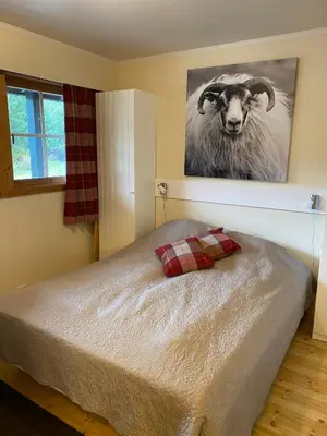a bedroom with a bed with a picture of a ram at Perfect Retreat for Small Families in Beitostøl
