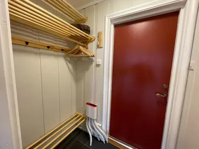 a red door in a room with a shelf at Perfect Retreat for Small Families in Beitostøl