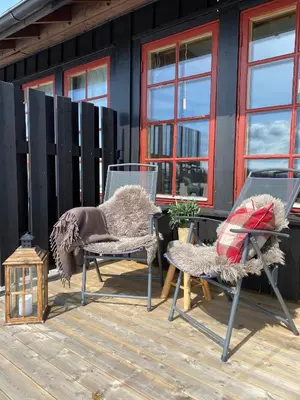 a couple of chairs and a table on a deck at Perfect Retreat for Small Families in Beitostøl