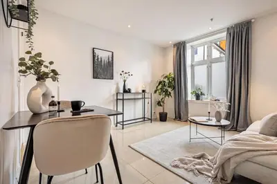 a living room with a table and a couch at Charming apartment in Sandviken in Bergen