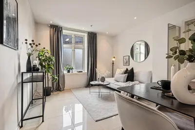 a living room with a table and a couch at Charming apartment in Sandviken in Bergen