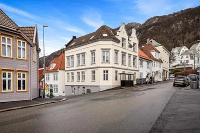 a street in a town with white buildings at Charming apartment in Sandviken in Bergen