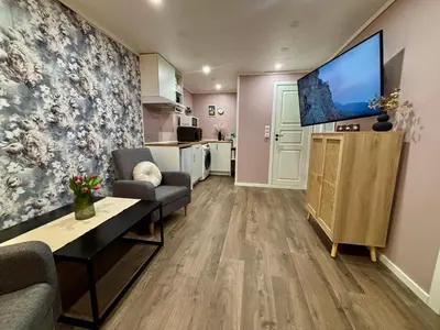 a living room with a large flat screen tv at Cozy Apartment in Ålesund