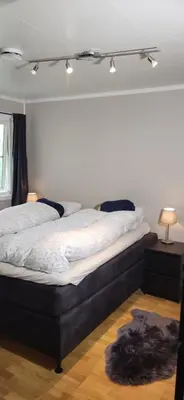 a bedroom with a large bed with white sheets at Dalgårdveien 5 in Trondheim