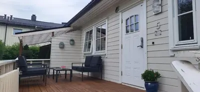 a patio with two chairs and a table on a house at Dalgårdveien 5 in Trondheim