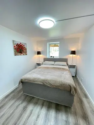 a bedroom with a large bed and two lamps at Charming Modern Apartment Close to Moa & Ålesund in Ålesund