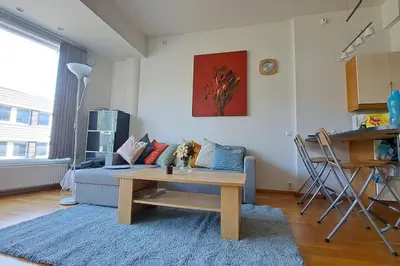 a living room with a couch and a table at Leilighet ved City Lade in Trondheim