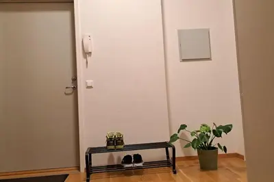 a room with a door and a table and a plant at Leilighet ved City Lade in Trondheim