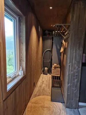 an empty room with a window and a staircase in a tiny house at Gaustablikk, 3 soverom, fri utsikt til fjell og innsjø in Gaustablikk