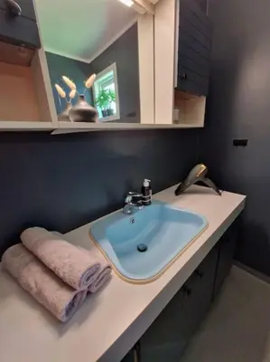 a bathroom with a sink and a towel on a counter at Fjellhagen - Geirangerfjord view in Hellesylt