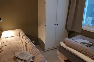 a bedroom with two beds and a window at Fjellhagen - Geirangerfjord view in Hellesylt