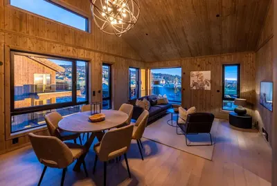 a living room with a table and chairs at Skistadion Hafjell in Hafjell