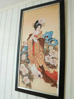 a framed painting of a woman on a wall at Trysil sentrum leilighet in Trysil