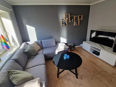 a living room with a couch and a table at Central and cosy apartment in Trondheim, Free parkingspot in Trondheim