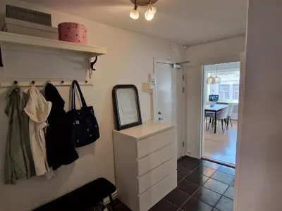 a bathroom with a vanity and a mirror and a table at Central and cosy apartment in Trondheim, Free parkingspot in Trondheim