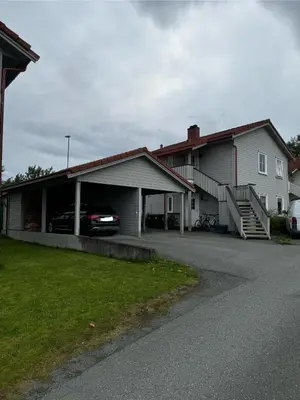 a house with a garage with a car in it at Big 2 bedrooms apartment 10 min from Granåsen, VM2025 in Trondheim