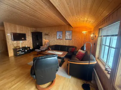 a living room with a couch and a table at Cozy 3-Bedroom Apartment Near Beitostølen Ski in Beitostøl