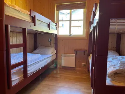 a room with two bunk beds and a window at Cozy 3-Bedroom Apartment Near Beitostølen Ski in Beitostøl