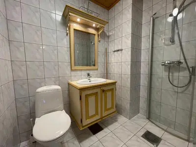 a bathroom with a toilet and a sink and a shower at Cozy 3-Bedroom Apartment Near Beitostølen Ski in Beitostøl