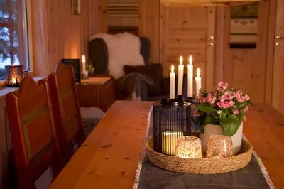 a dining room table with candles and cakes on it at Koselig familiehytte på Rømåsen in Ringsaker
