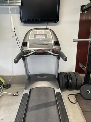 a room with a treadmill and a tv on a wall at Presthusvegen in Trondheim