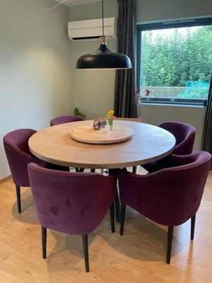 a dining room table with purple chairs around it at Presthusvegen in Trondheim