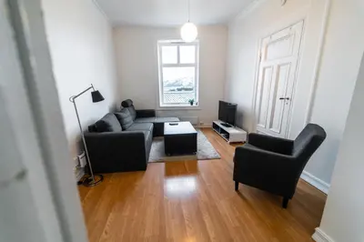 a living room with a couch and two chairs at Leilighet i Ålesund Sentrum in Ålesund