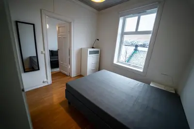 a bedroom with a bed and a window and a dresser at Leilighet i Ålesund Sentrum in Ålesund