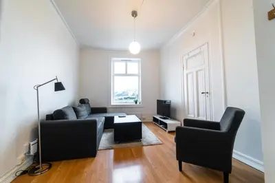 a living room with a couch and two chairs at Leilighet i Ålesund Sentrum in Ålesund