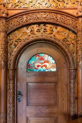 a wooden door with a stained glass window above it at Jervell 2 BnB in Ålesund