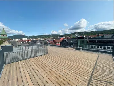 a wooden deck with a view of a city at midt i Lillehammer in Lillehammer