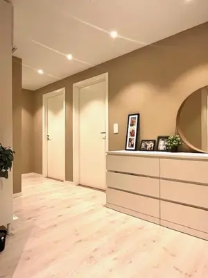 a hallway with two white doors and a mirror at House close to World cup Trondheim 2025 in Trondheim