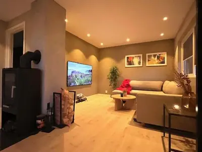 a living room with a couch and a flat screen tv at House close to World cup Trondheim 2025 in Trondheim