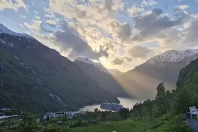 a view of a river in a valley with mountains at Tømmerhus i Geiranger Sentrum med panorama utsikt in Geiranger