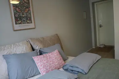 a couch with pillows on it in a living room at One-bedroom apartment close to NTNU and St Olavs in Trondheim