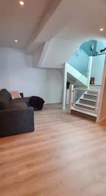 a living room with a couch and a bunk bed at Villa with a view in Ålesund